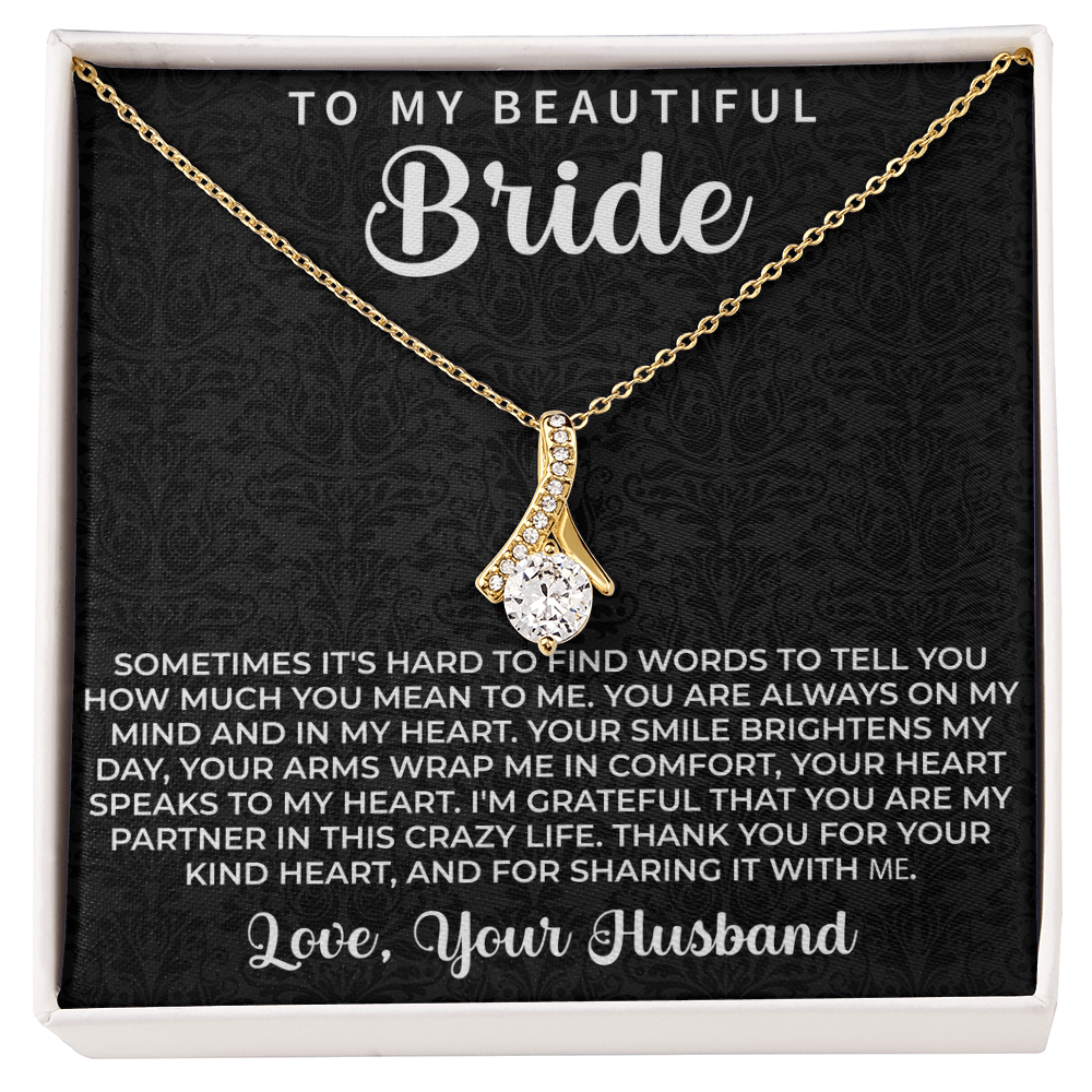 close up of a delicate pendant necklace chosen as a meaningful gift for the bride