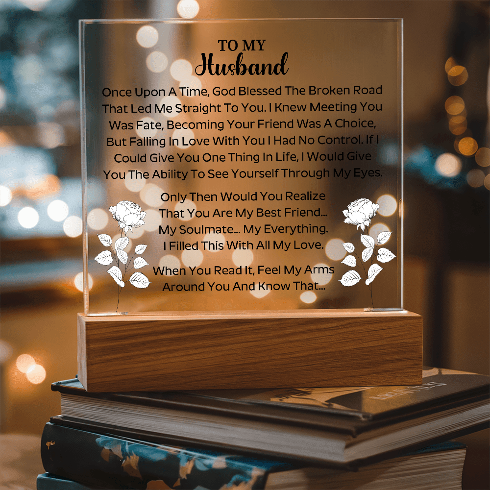 husband holding a beautifully engraved acrylic plaque in a joyful moment