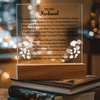 husband holding a beautifully engraved acrylic plaque in a joyful moment