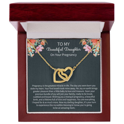 emotional gifting moment featuring a Giftsignature necklace given to a pregnant daughter